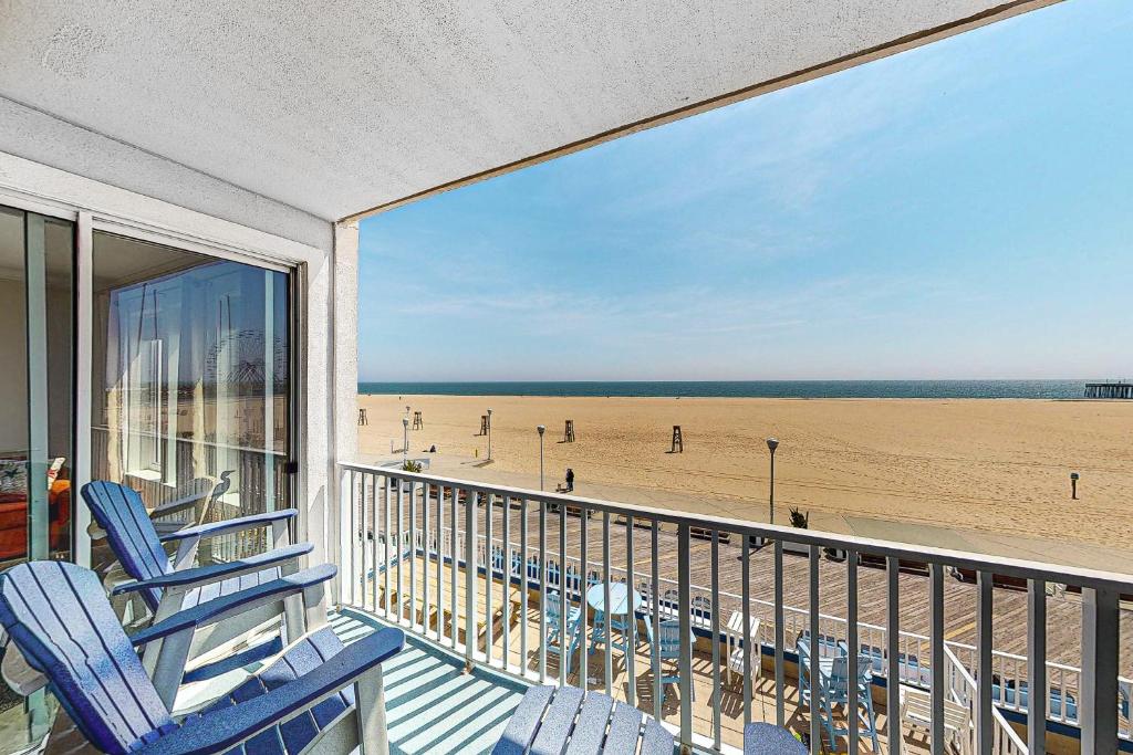 a balcony with chairs and a view of the beach at Belmont Towers 401 in Ocean City