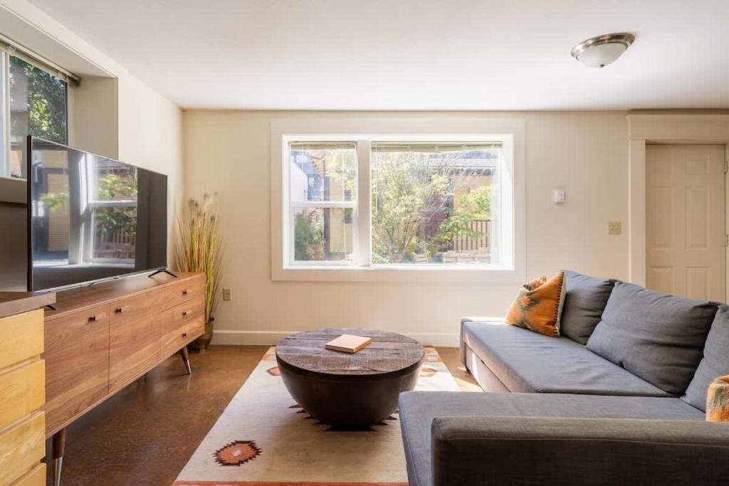 a living room with a couch and a tv at Desert Vibe 1BR in SE PDX - Local Bars & Food in Portland