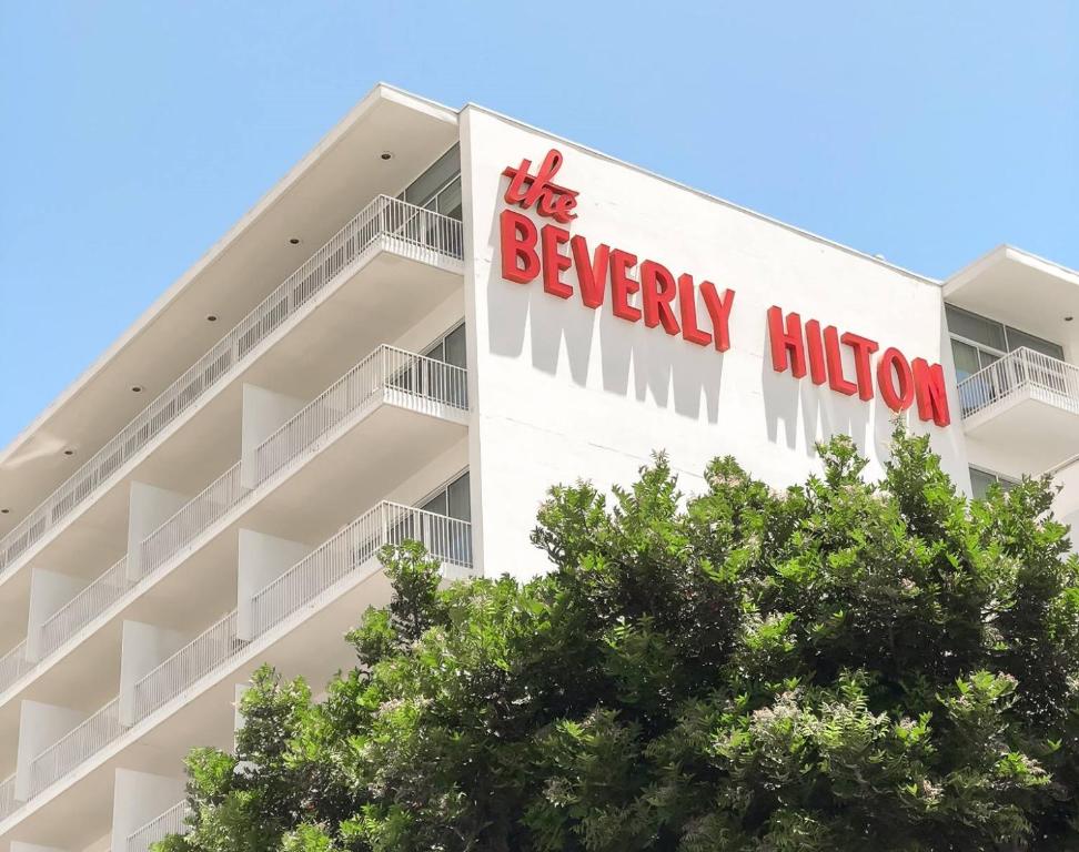 a building with a sign for the beverley billion at The Beverly Hilton in Los Angeles