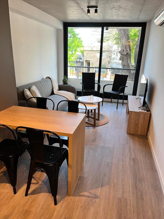 a living room with a couch and a table and chairs at Link in Montevideo