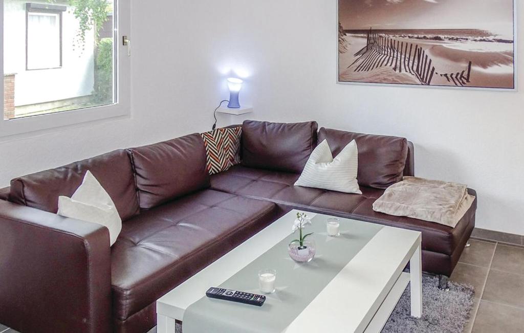 a brown leather couch with a coffee table in a living room at Cozy Home In Schwerin With Wifi in Wittenförden