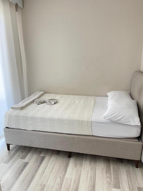 a bed sitting in a room with a wooden floor at Maraş Blue Life Suit in Kahramanmaraş