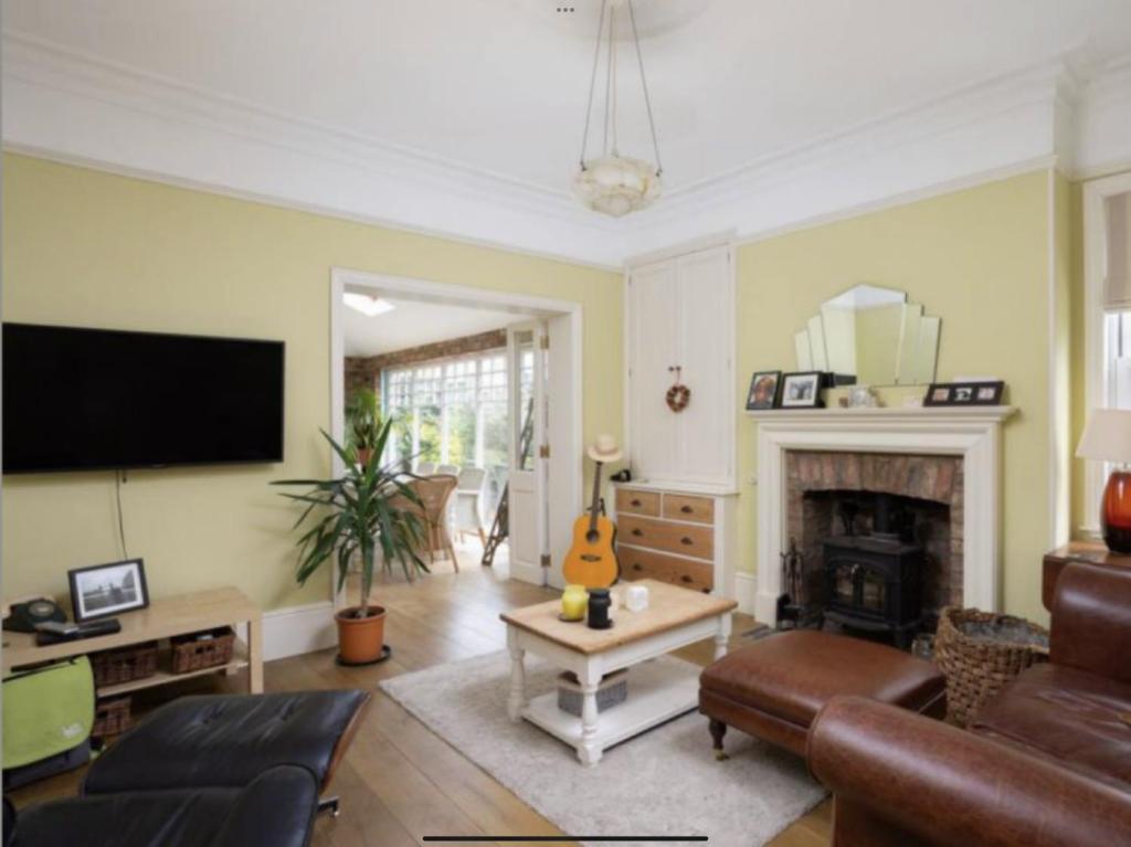 a living room with a couch and a fireplace at Entire three bed house in wigginton, York in York