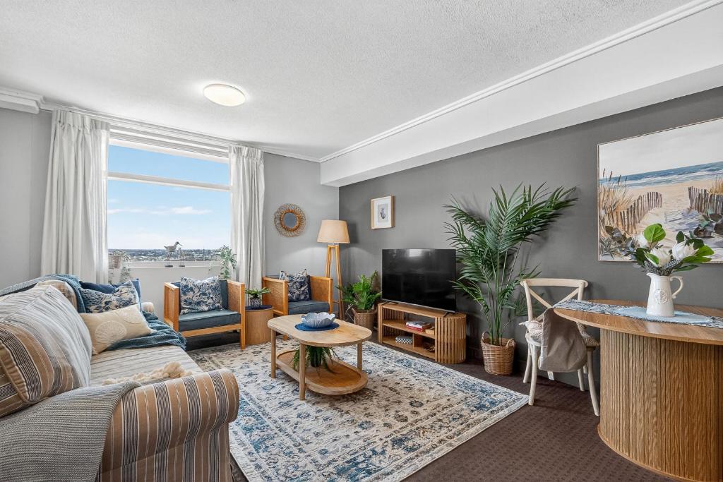 a living room with a couch and a tv at Coastal Escape with River Views in Casino Towers in Brisbane