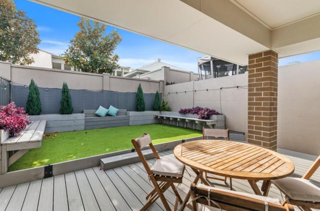 a patio with a table and chairs on a deck at The Stayover Unit 2 - Your Wine Country Base in North Rothbury