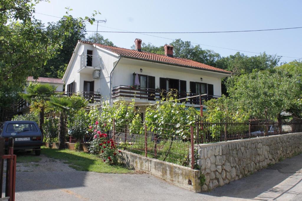 a white house with a fence in front of it at Apartments with parking space Opric, Opatija - 7695 in Opric