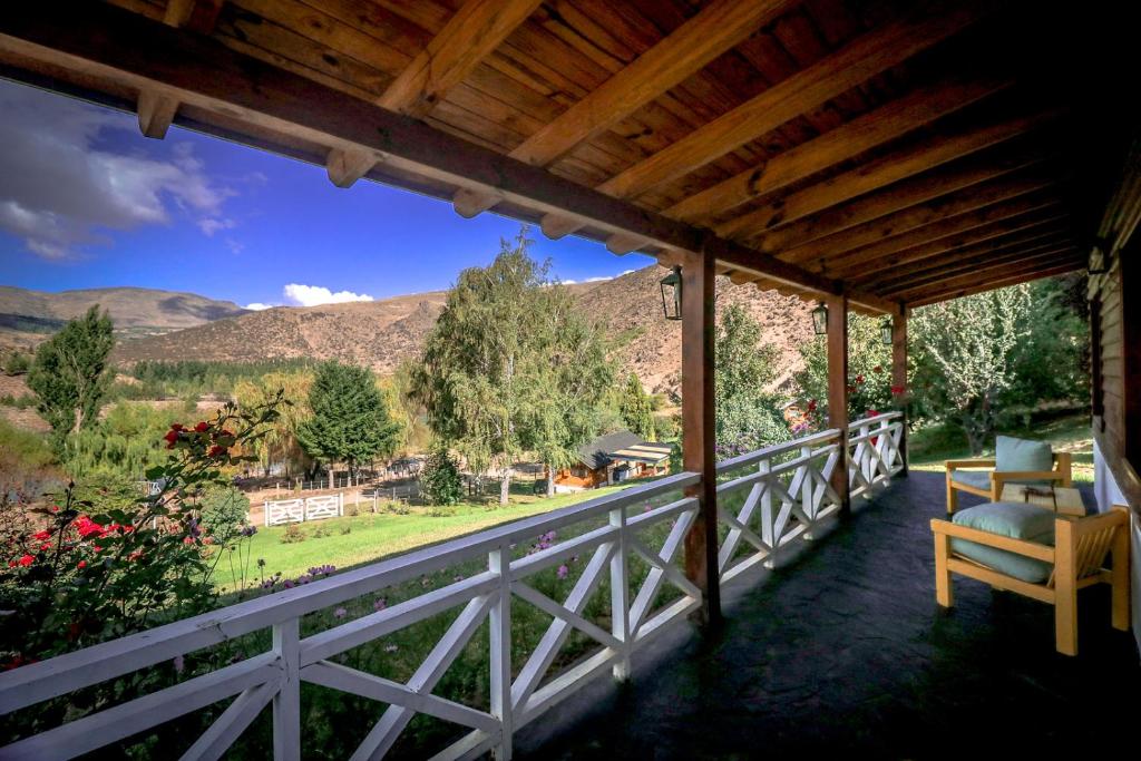 a porch with a view of the mountains at Nahuel Mapi Lodge in Pilolil