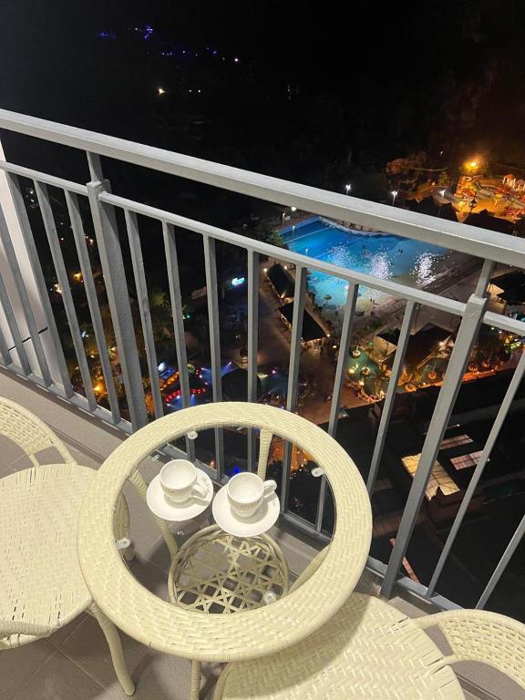 a balcony with a table and two hats on it at Sunway Onsen beautiful view 4-6pax in Tambun