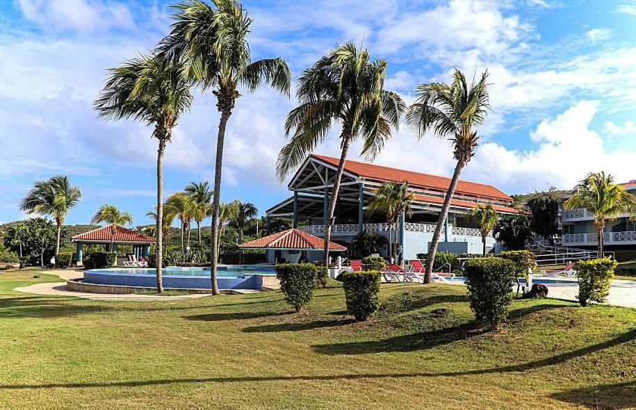 a resort with palm trees and a swimming pool at Costa Bonita Private Villas in Culebra