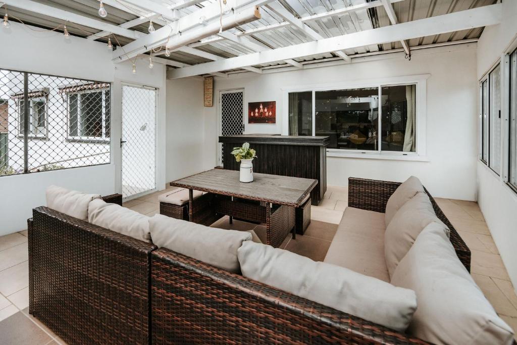 a living room with a couch and a table at The Waratah Escape Nowra in Nowra