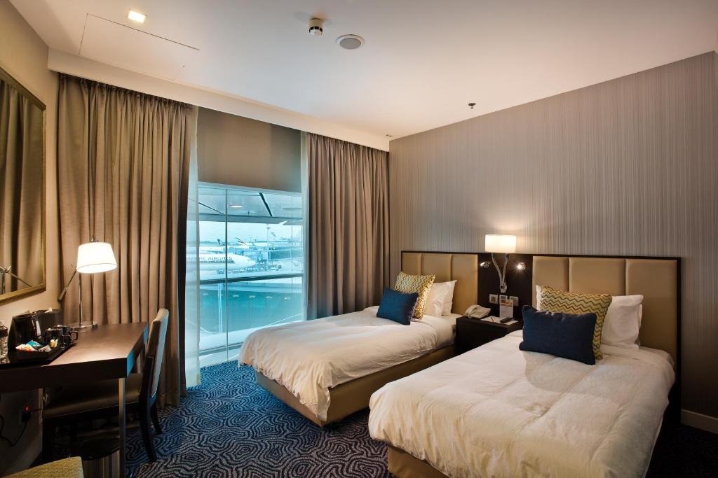 Postel nebo postele na pokoji v ubytování Ambassador Transit Hotel - Terminal 3
