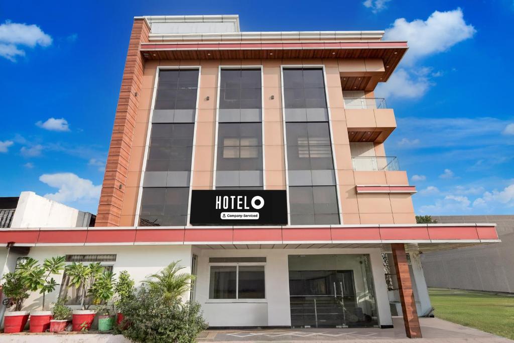 a building with a hotel sign on it at Collection O Ranipur - Dhaney Crossway Formerly Saroj Inn in Bhāda