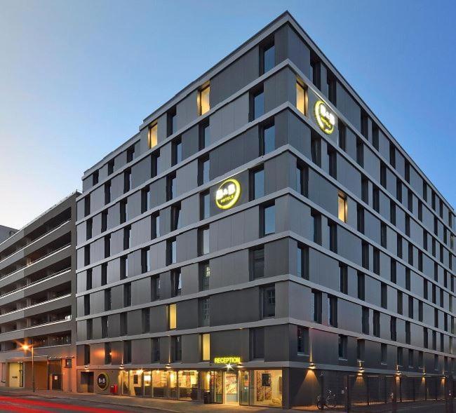 un gran edificio negro con un reloj en él en B&B HOTEL Berlin-Alexanderplatz, en Berlín