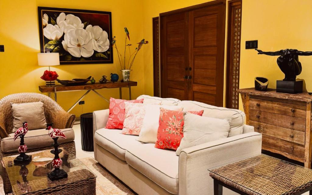 a living room with a white couch and a table at Casa Acantilado Oslob - 3BR in Oslob