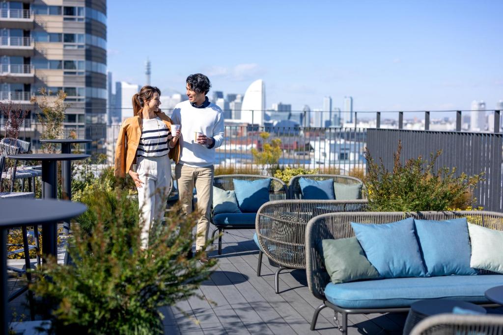 a man and a woman walking on a roof at The Gate Hotel Yokohama by Hulic in Yokohama