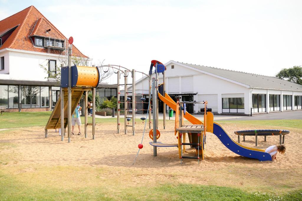 a playground with a slide and a swing set at Corsendonk Duinse Polders in Blankenberge