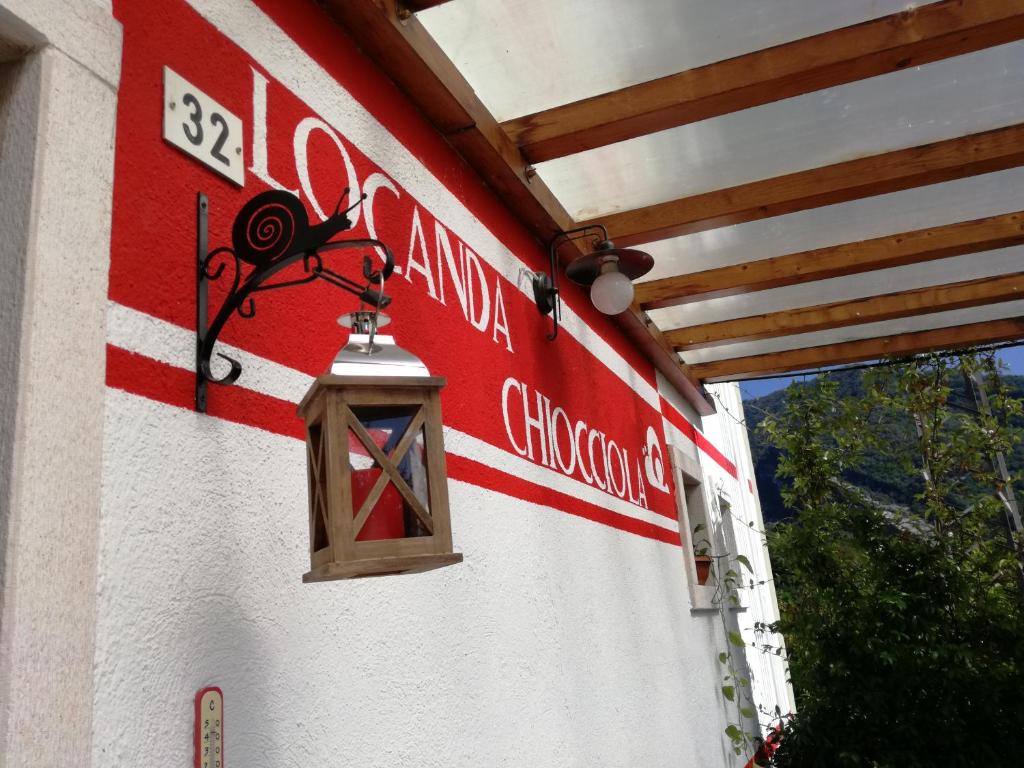 a red and white building with a light on it at Locanda Chiocciola in Quero