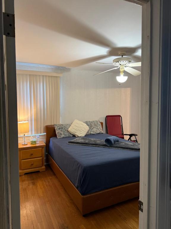 a bedroom with a bed and a ceiling fan at Master Bedroom with Attached SunRoom and Attached Patio in Richmond