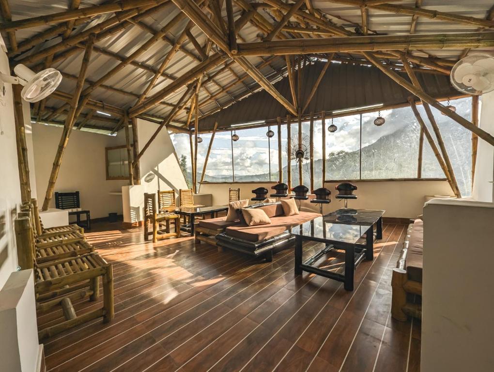 a living room with a couch and a table at Dzukou Lodge in Kohīma