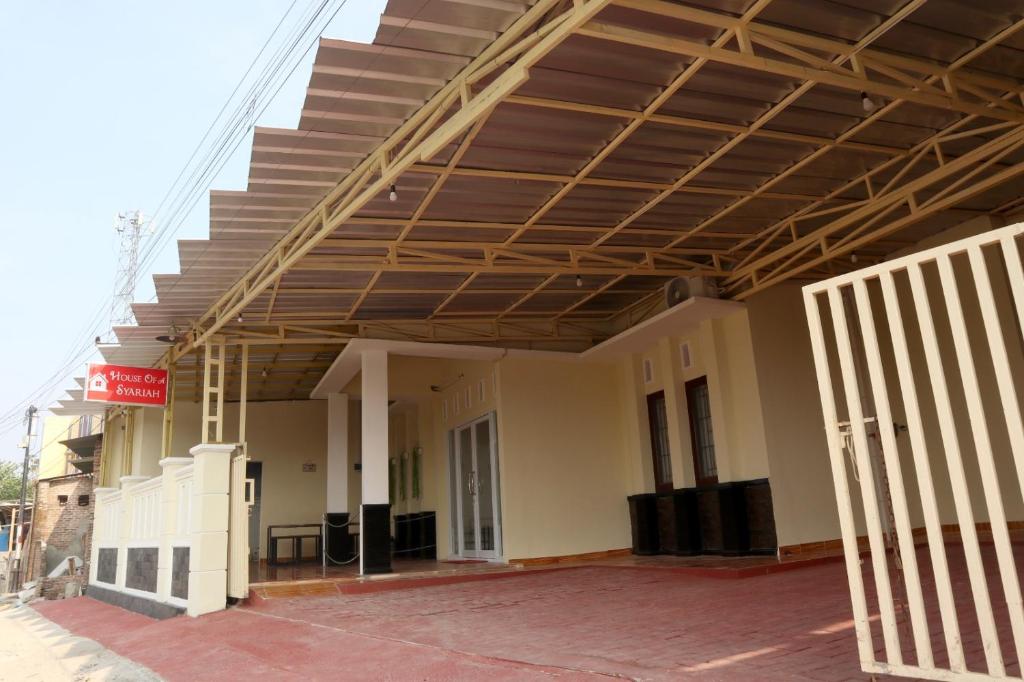 a building with awning and stairs on top of it at House of A Syariah Kedamaian in Bandar Lampung
