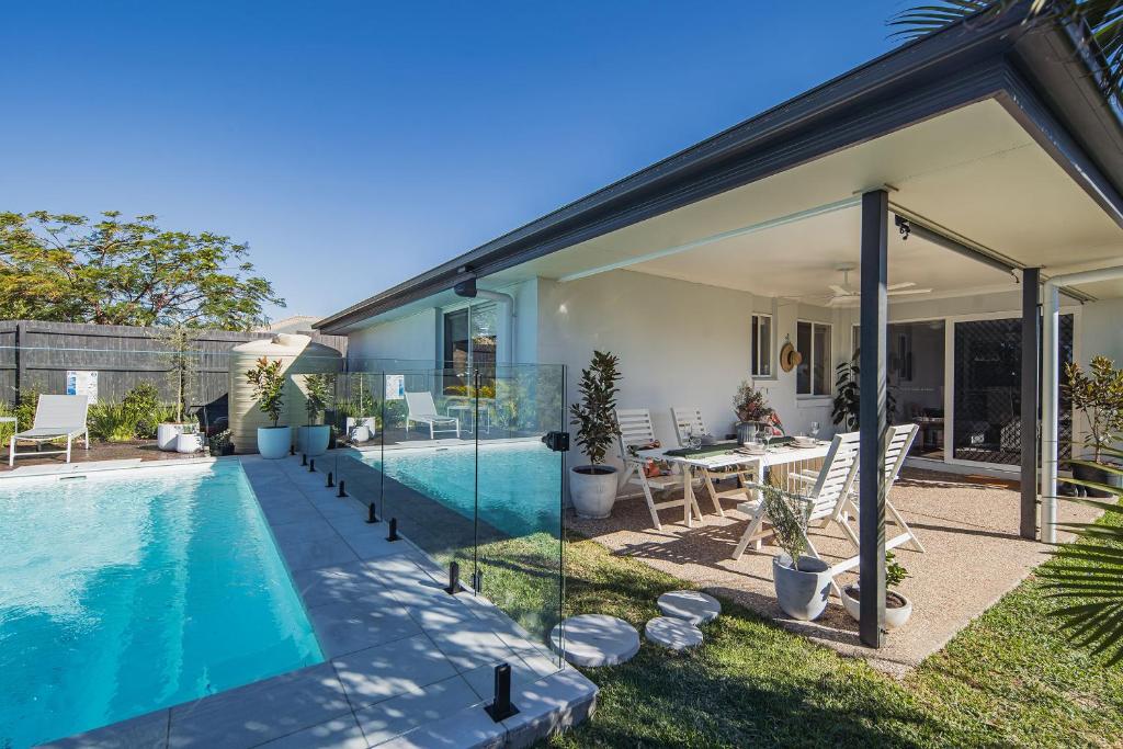 a house with a swimming pool and a patio at Nora Poolhouse Oasis, 4-beds house, North Lakes in North Lakes