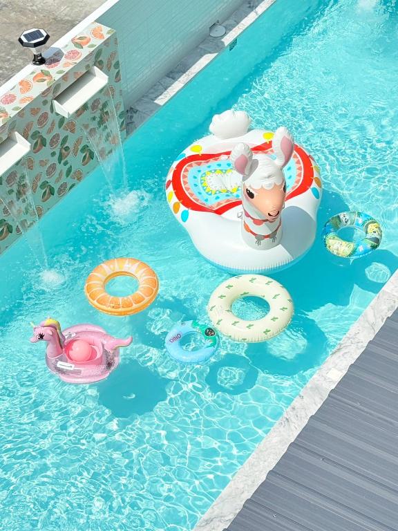 a pool with an animal in an inflatable at The Ocean Pool Villa HuaHin in Hua Hin