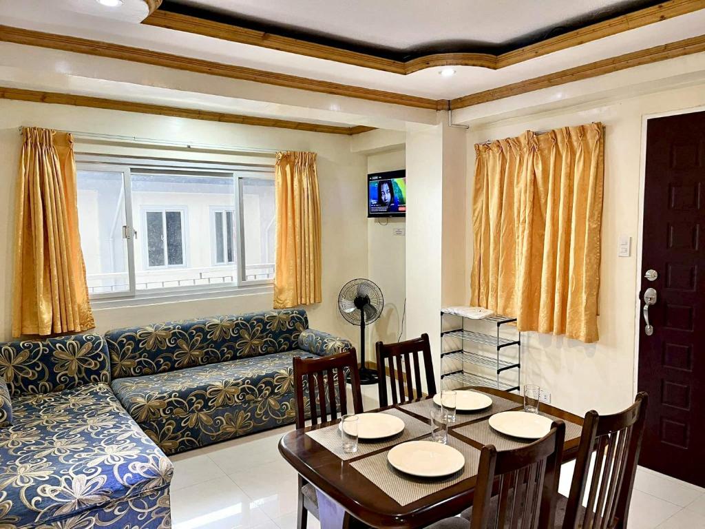 a living room with a couch and a table at TPRC Residences in Baguio