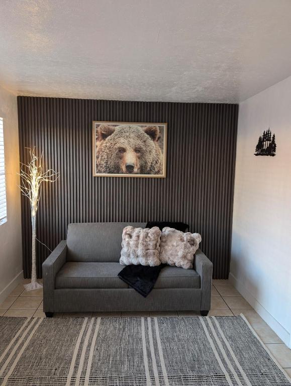 a living room with a couch with a picture of a bear at Bear cave in Tucson