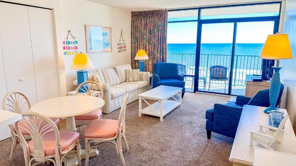 a living room with a couch and a table and chairs at Verandas 602 in North Myrtle Beach