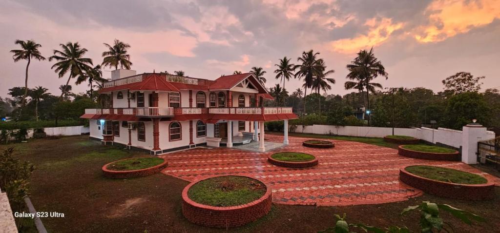 a house with a red roof on a brick yard at Janiszel Heaven- A Zion Legacy in Putuppalli