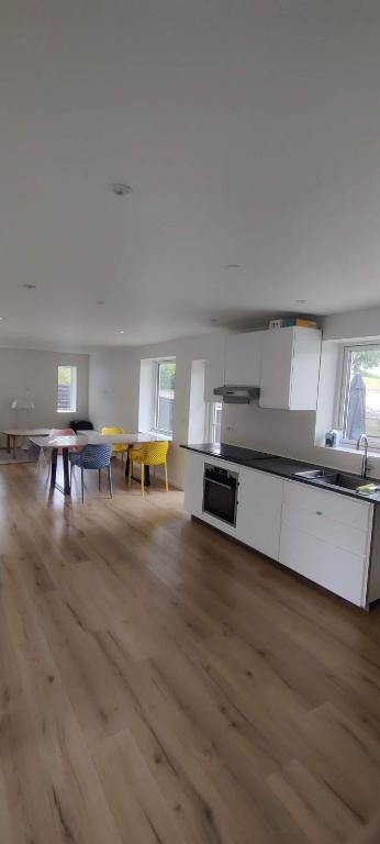 an empty room with a kitchen and a table and chairs at House in Ølst, Randers SV in Randers