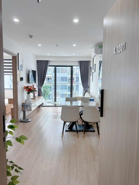 a dining room and living room with a table and chairs at Thương Apartment 2 in Thôn Văn Dương