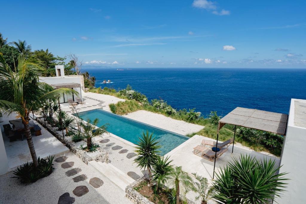 an aerial view of a villa with a swimming pool and the ocean at Cliffside Haven in Nusa Penida in Nusa Penida