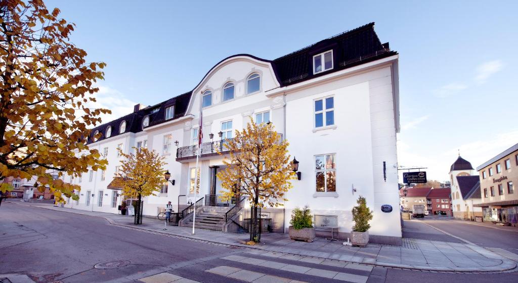 a white building on the side of a street at Clarion Collection Hotel Atlantic in Sandefjord