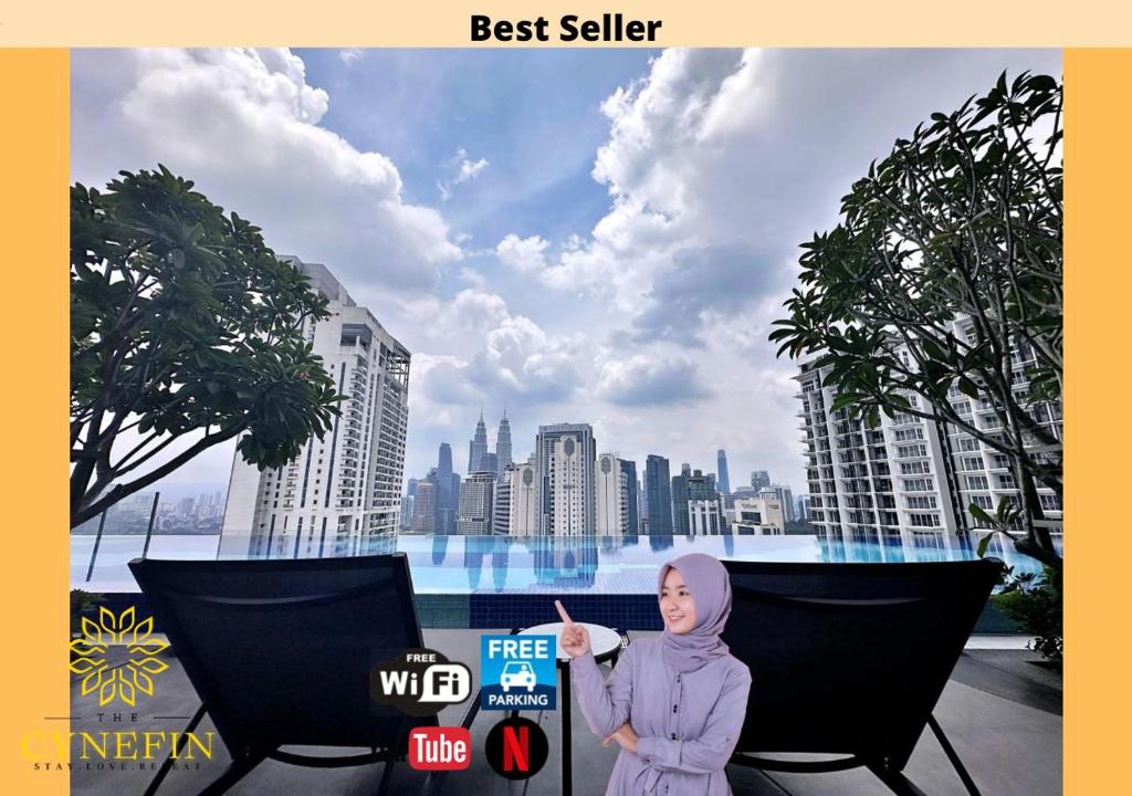 a woman standing in front of a view of a city at Majestic Residence Kuala Lumpur near Bukit Bintang & Chow Kit in Kuala Lumpur