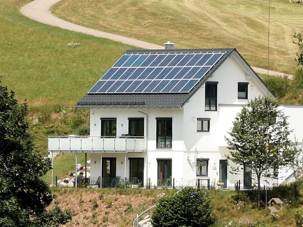 a house with solar panels on the roof at Ferienwohnung Kuckucksnest in Unterkirnach