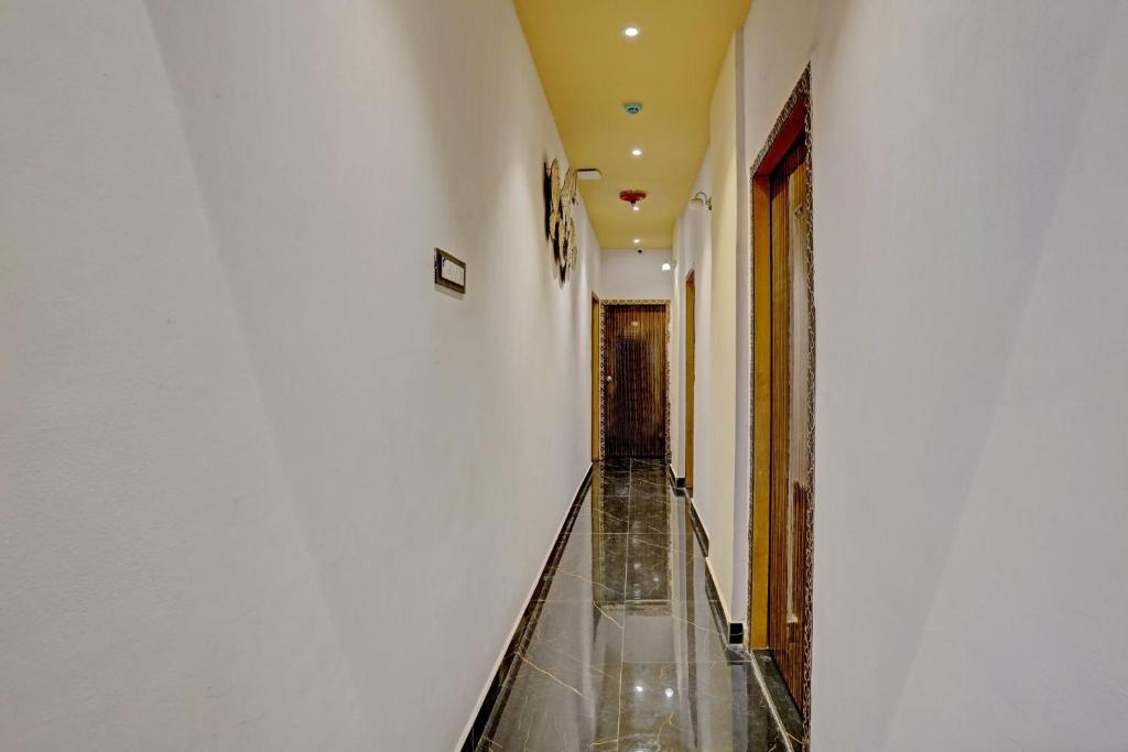 an empty corridor in a building with a glass floor at Super Hotel O Golden Suites in Turambhe