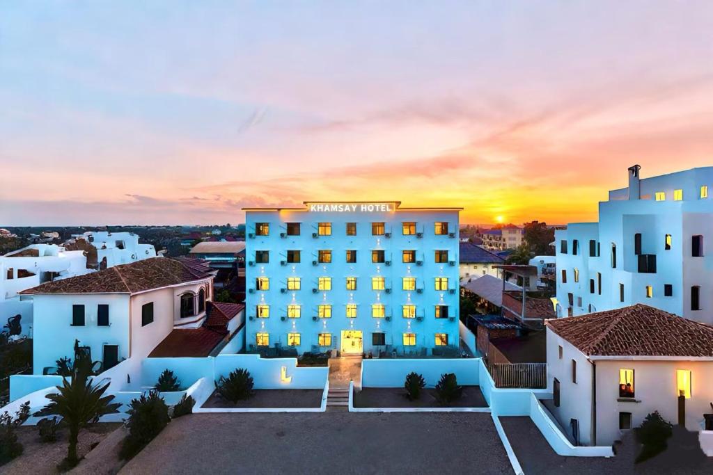 a view of a hotel with the sunset in the background at Khamsay Hotel in Vientiane