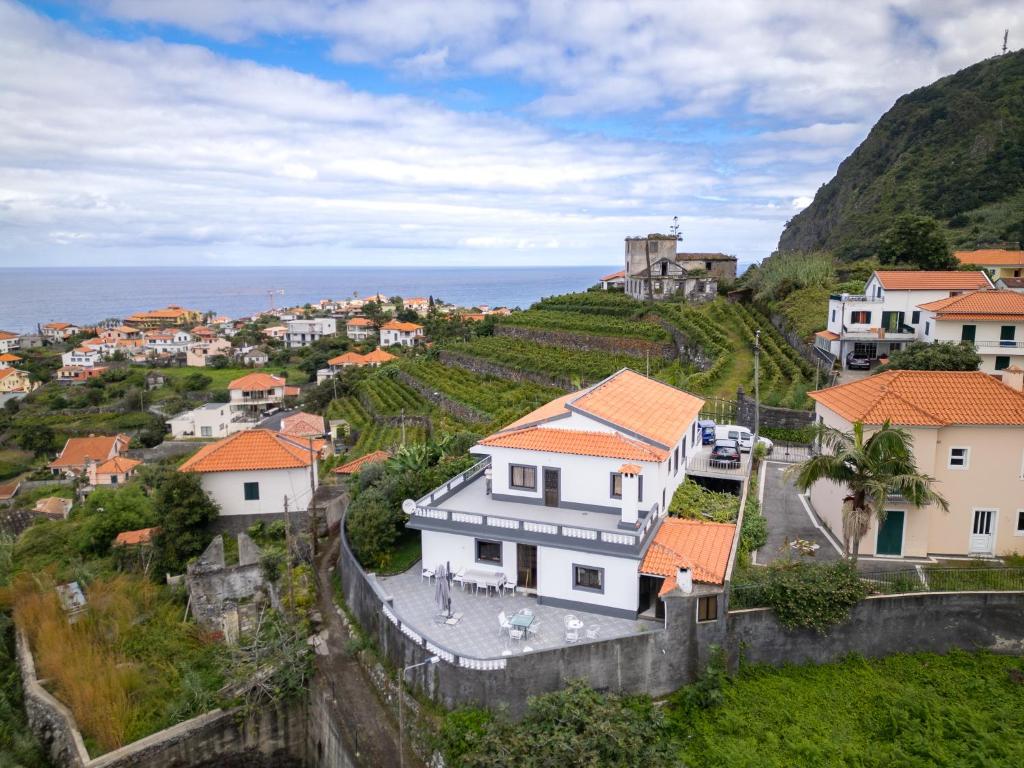 a village on a hill next to the ocean at Solar do Pico Studio in Ponta Delgada