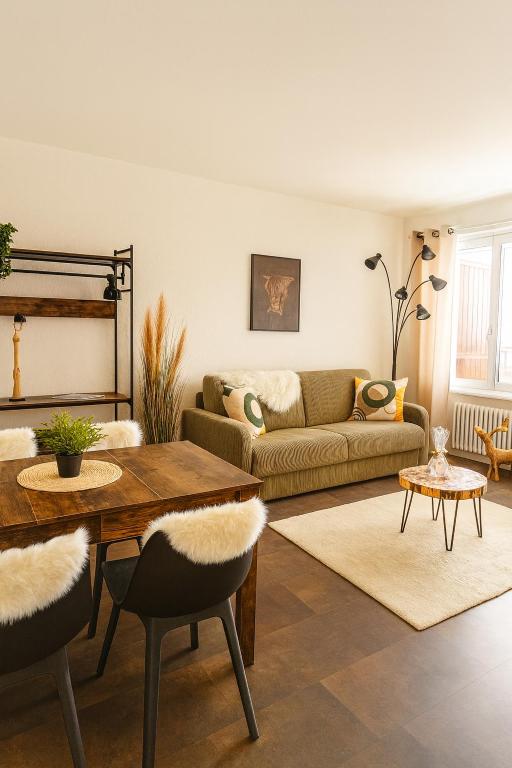 a living room with a couch and a table at Studio au Cœur des Sommets in Crans-Montana