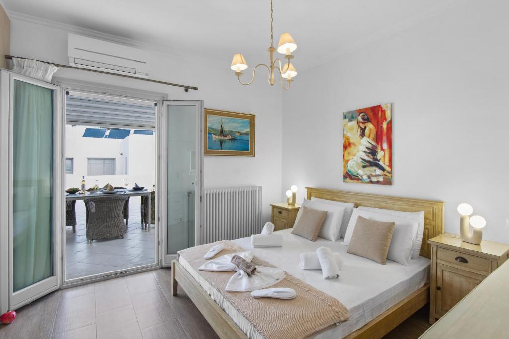 a bedroom with a large bed and a balcony at Panos Apartment Naousa in Naousa