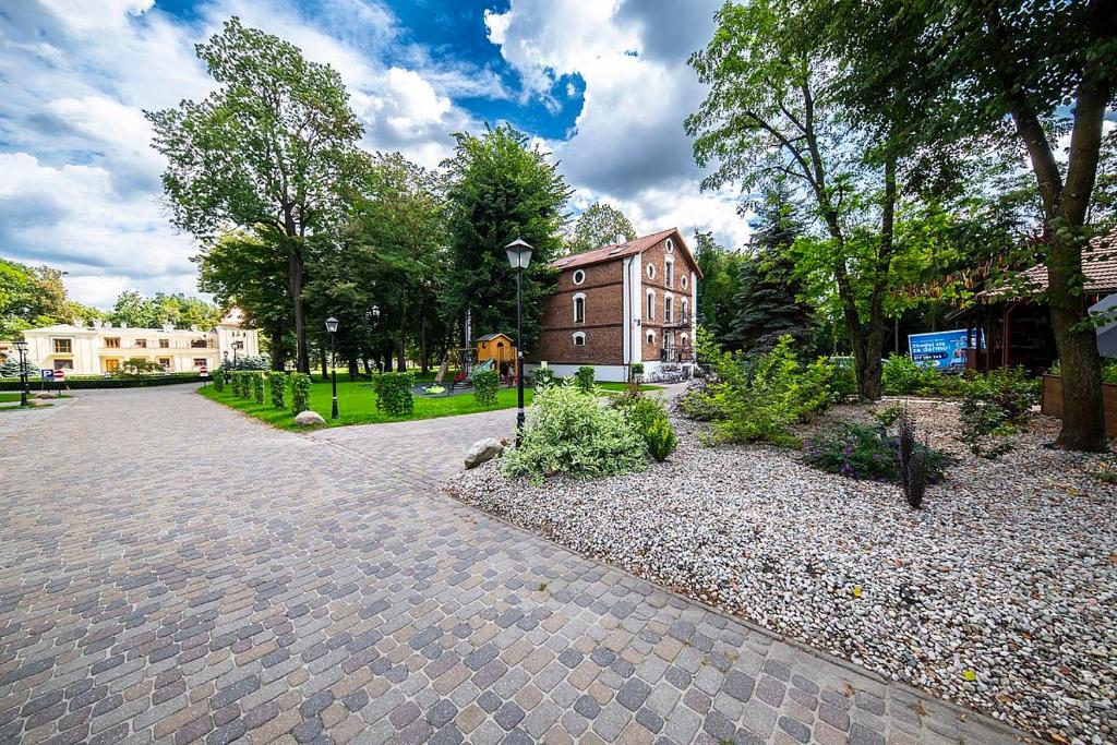 a brick walkway with a building in the background at Spichlerz Ostoya in Jasionka