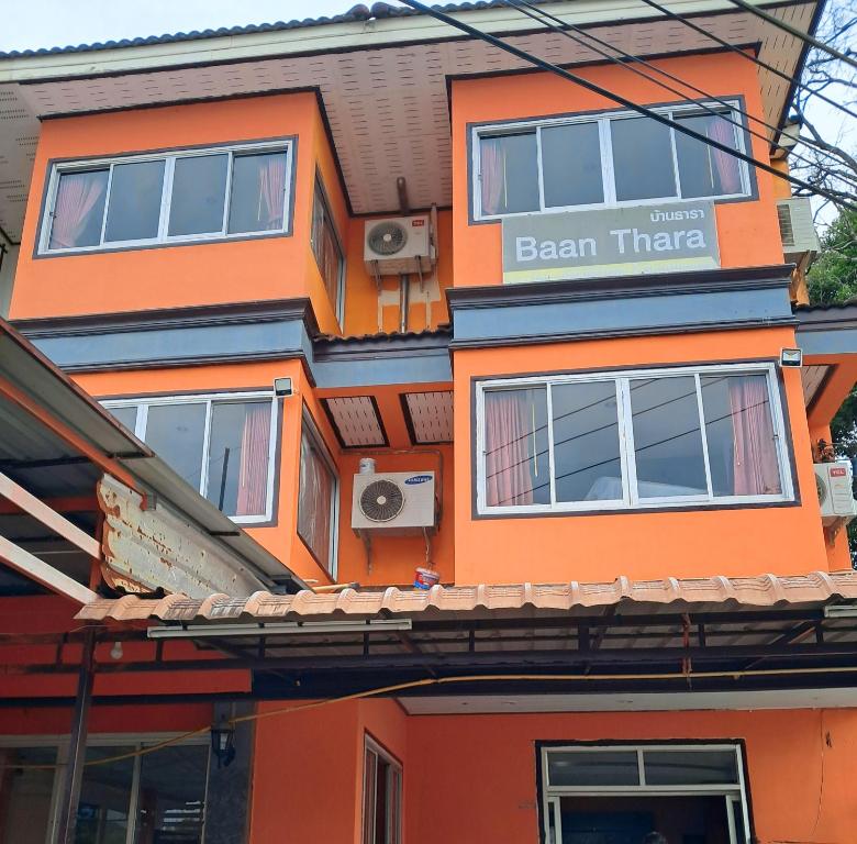 an orange building with a sign that reads beam there at Baan Thara Guesthouse in Ao Nang Beach