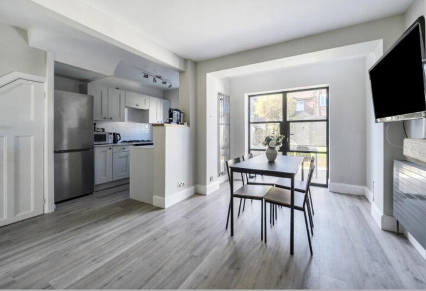 a kitchen and dining room with a table and chairs at Recently renovated 3 bed home in Southampton