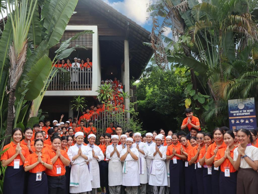 a group of people standing in front of a building at Sala Baï Hotel & Restaurant School in Siem Reap
