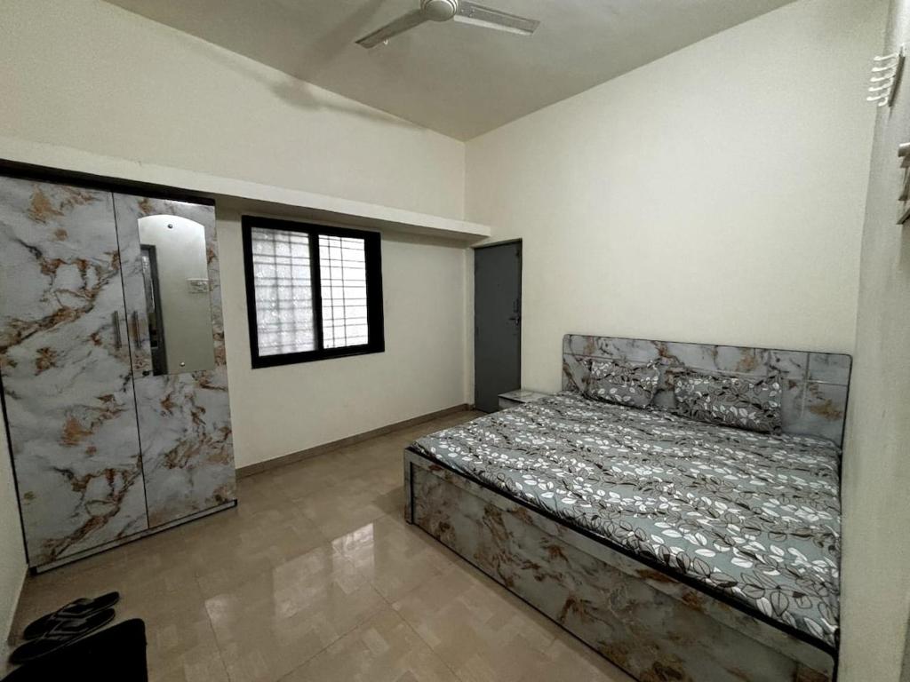 a bedroom with a bed in a room with a window at 2BHK Nature Stay in Wādhiware