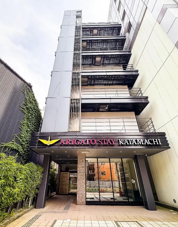 an office building with a sign in front of it at Arigato Stay Kanazawa Katamachi in Kanazawa