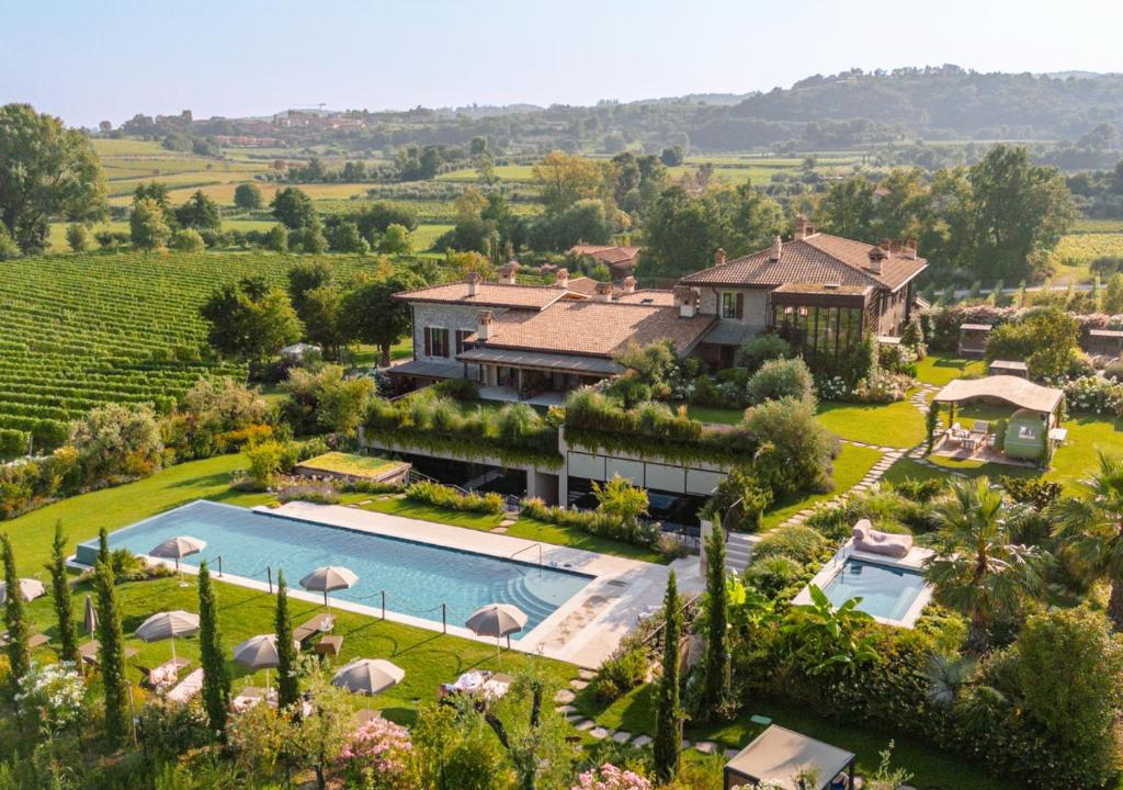 an aerial view of a villa with a swimming pool at Conti Thun Wine Resort in Puegnano del Garda