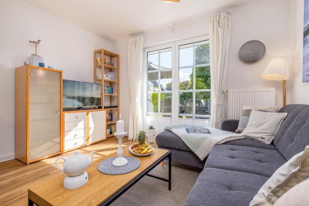 a living room with a couch and a table at Haus Kranichwiese in Zingst