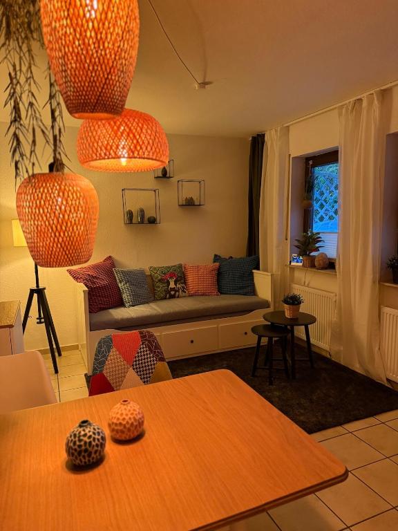 a living room with a couch and a table at Maison Kaiser - Studio apartment in Wadern